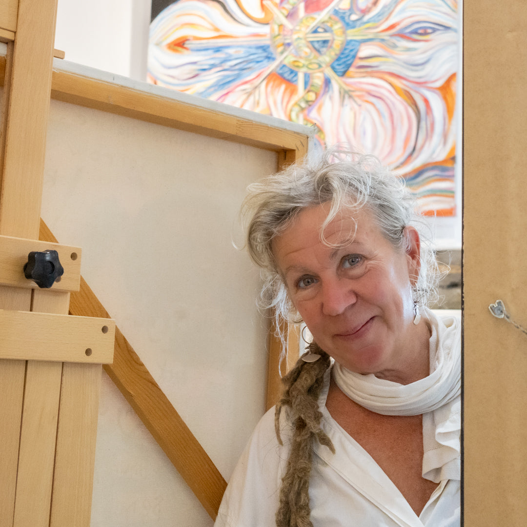 Eliska Smiley, peeking around a painting on an easel.