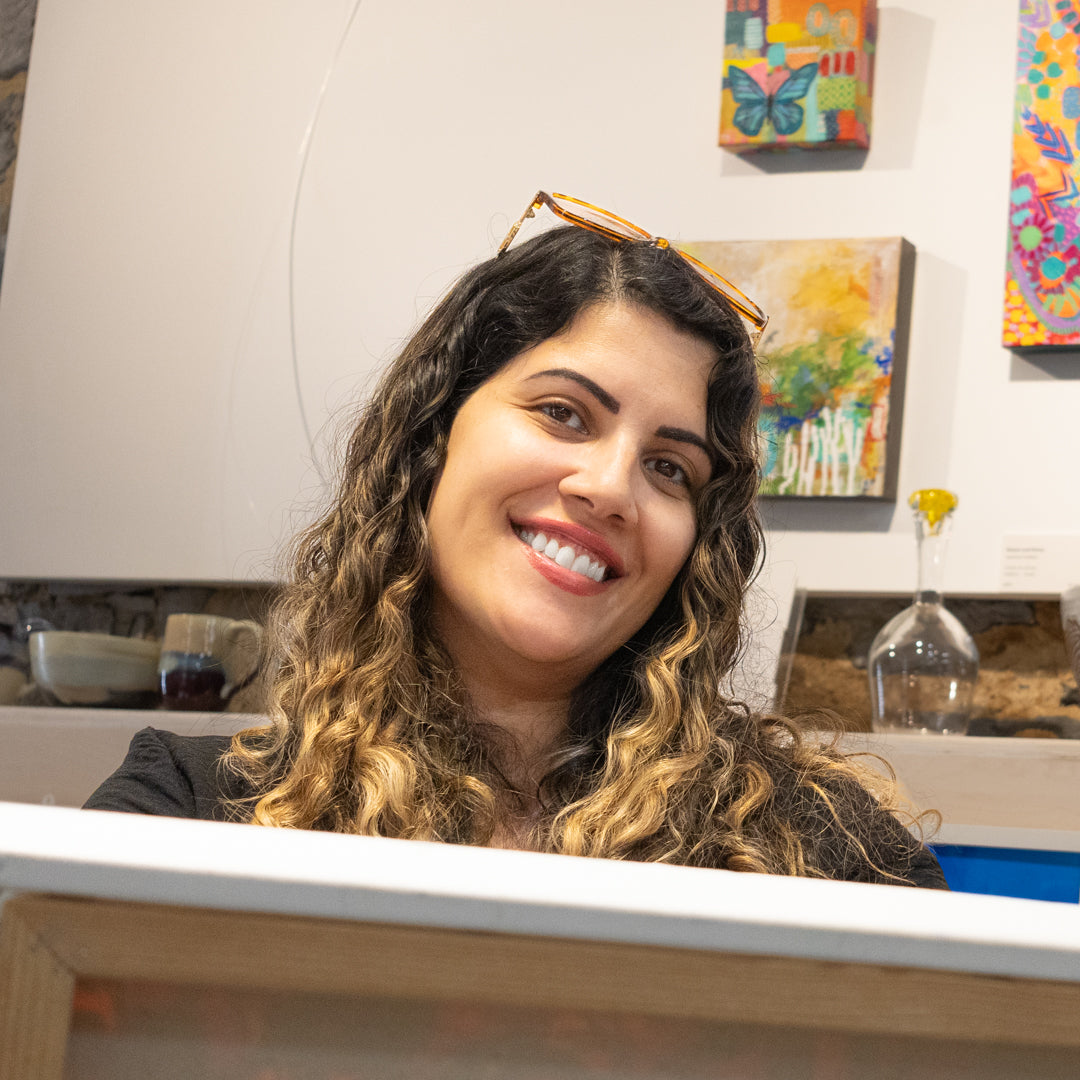 Jasmine Dhillon posing with her artwork in the PMAC studio