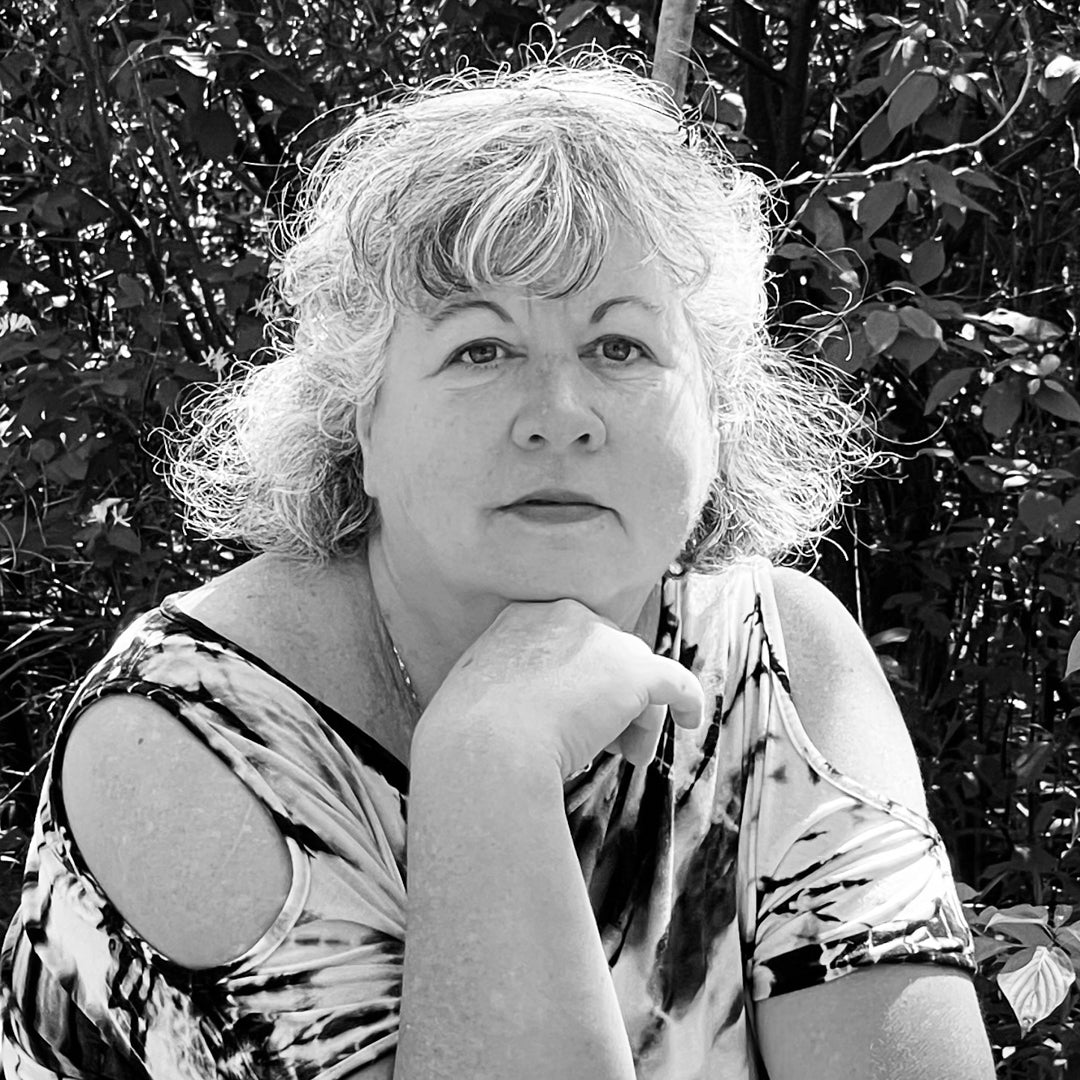 Black and white image of Jennifer Robitaille posing with chin resting on her hand.