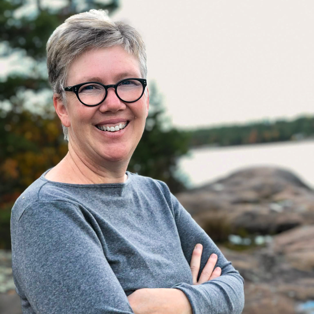 Photograph of Jody Pilon posing at a lake.